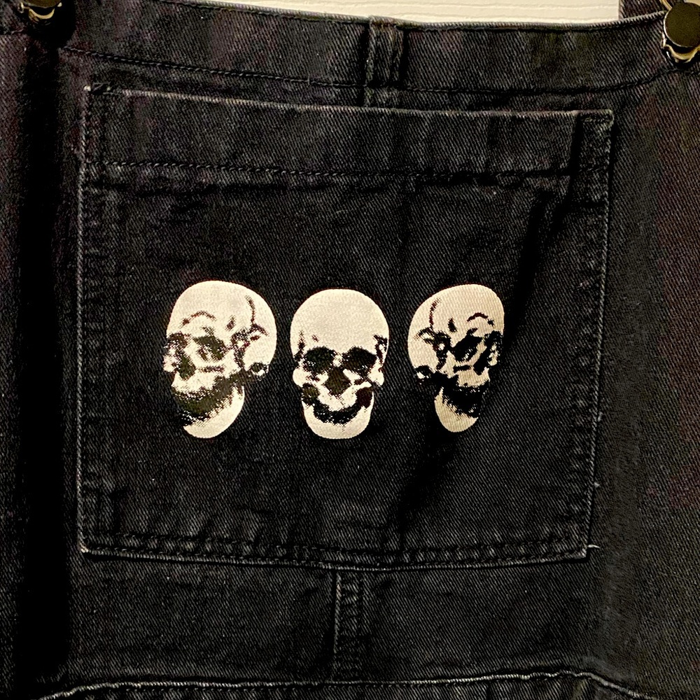 Black jeans, overalls with skull design